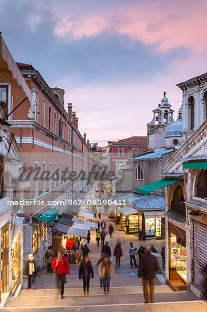 Italy, Veneto, Venice. Souvenir kiosks near Rialto bridge at sunset