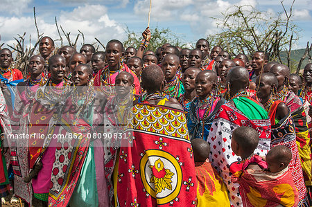 Africa, Kenya, Narok County, Masai Mara. Masai women dancing at their homestead.