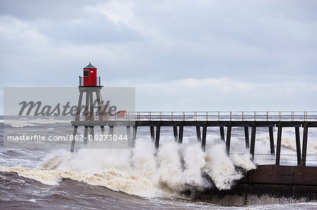 United Kingdom, England, North Yorkshire, Whitby. The East Pier during a Winter storm.