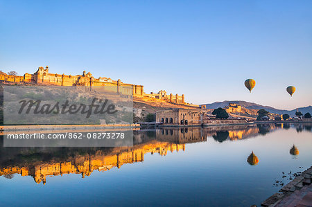 India, Rajasthan, Jaipur, Amer.  The magnificent 16th century Amber Fort at sunrise with two hot air balloons aloft.