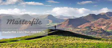 England, Cumbria, Keswick. A hiker with a panoramic view of the Western Fells. MR.