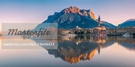 Lecco, lake Como, Lombardy, Italy. Panoramic view of the city at sunrise with the St. Martin mount reflected in the lake's waters