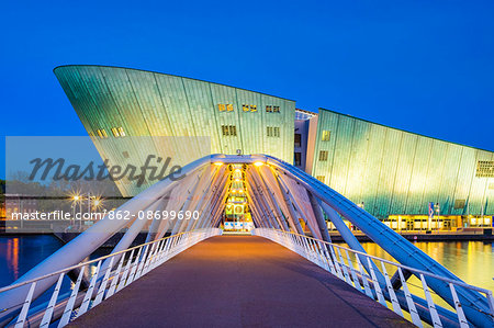 Netherlands, North Holland, Amsterdam. Science Center NEMO science museum at dusk, designed by Renzo Piano.