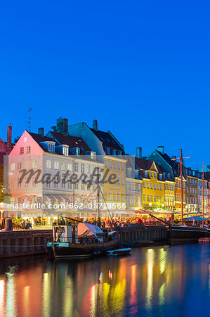 Denmark, Hillerod, Copenhagen. Colourful buildings along the 17th century waterfront of Nyhavn at dusk.