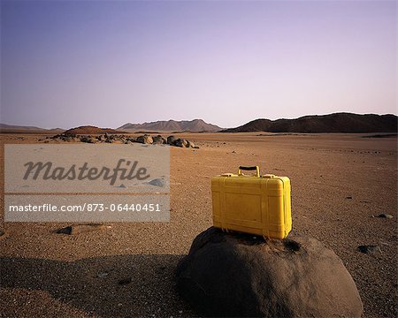 Suitcase on Rock in Arid Landscape, Brandberg Area Namibia, Africa