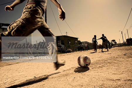 Boys playing soccer in the township