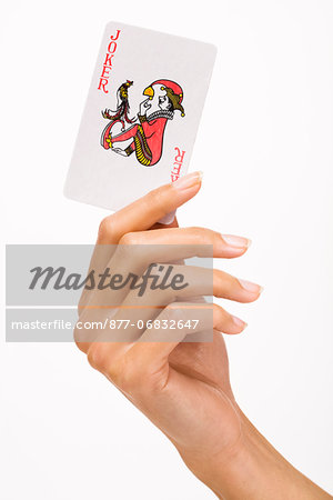 Woman's hand holding a playing card (joker)