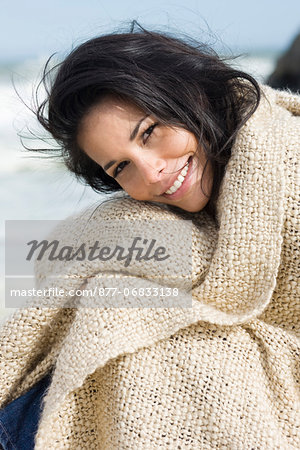 Young woman with shawl at seaside