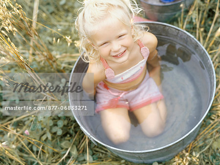 Little girl in metal basin