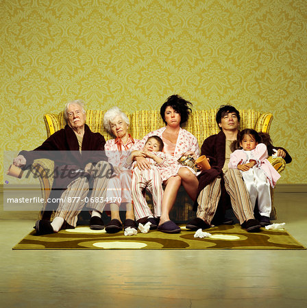 Three generation family sitting sick in sofa