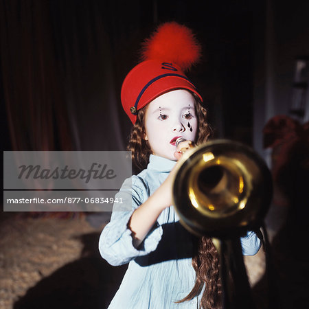 Little girl playing music in the circus