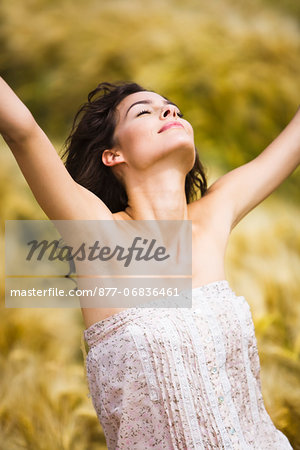 Young woman streching in wheat field