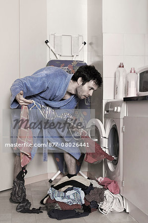 a man empties the washing machine