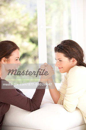 Mother and daughter arm wrestling