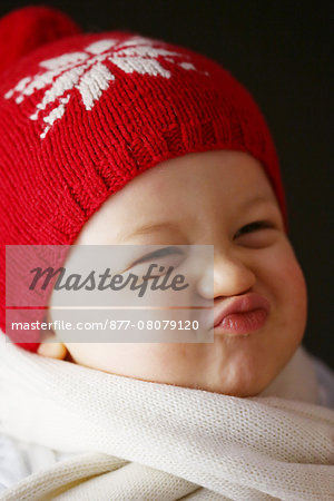 A 15 months baby boy with a cap and a scarf A 15 months baby boy with a cap and a scarf