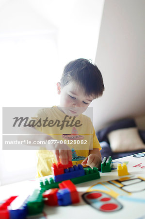 A boy playing with Lego