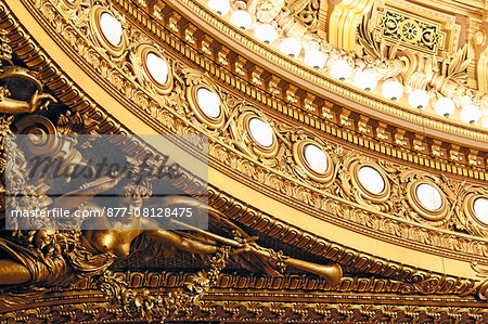 France,Paris. 9th district. Palais Garnier, Paris Opera. La Salle de Spectacle. Detail of gilding and sculptures at the base of the ceiling.