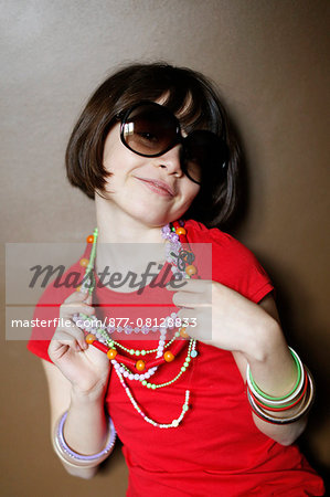 Little girl with sunglasses and necklaces