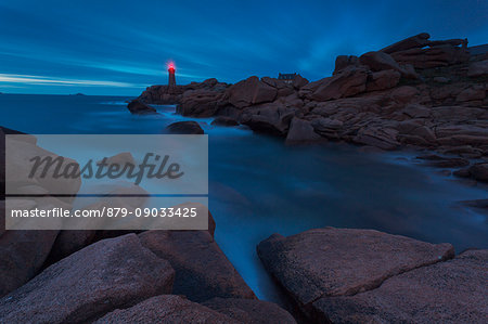 Mean Ruz lighthouse, Brittany, France. The Ploumanach's lighthouse one hour after sunset during the rising tide