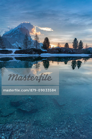 Europe, Italy, Veneto, Falzarego, Belluno. Morning view of the Tofana di Rozes reflected in the calm water of the Limedes lake, Dolomites