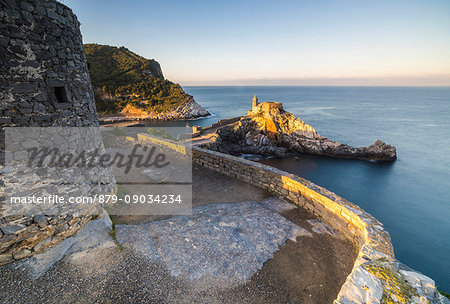 Sunrise on the old castle and church perched on the promontory Portovenere province of La Spezia Liguria Italy Europe