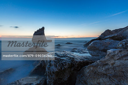 Blue light at dusk on cliffs framed by clear sea La Vela Beach Portonovo province of Ancona Conero Riviera Marche Italy Europe