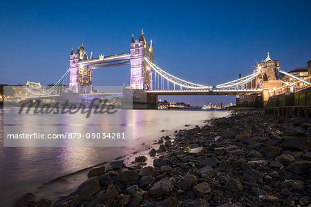 Night view of the Tower Bridge reflected in river Thames London United Kingdom