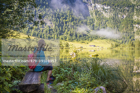 A girl looking at Lake Konigsee, Berchtesgaden Land, Bayern, Germany.