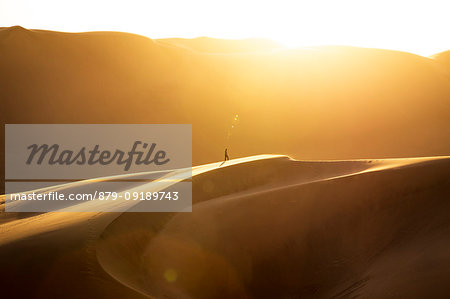 Lonely man in the desert at sunset,Walvis Bay,Namibia,Africa