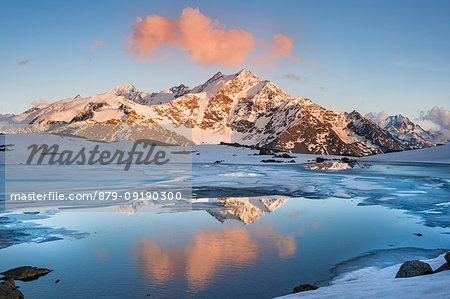 Manzina lake at sunset during spring. Santa caterina Valfurva, Valdidentro, Lombardy, Italy.