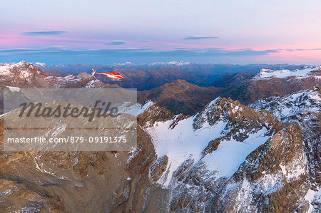 Aerial view of helicopter in flight on peaks of the Bernina Group, border of Italy and Switzerland