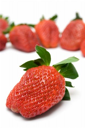 simsearch:400-07993543,k - Bunch of Strawberries. Front one focused. Isolated on a white background. Photographie de stock - Aubaine LD & Abonnement, Code: 400-04004053
