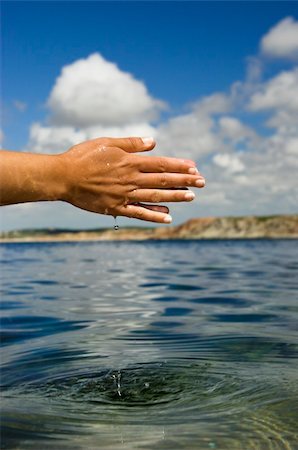 simsearch:400-06479158,k - Close up of woman hands catching water from the ocean Stock Photo - Budget Royalty-Free & Subscription, Code: 400-04004093