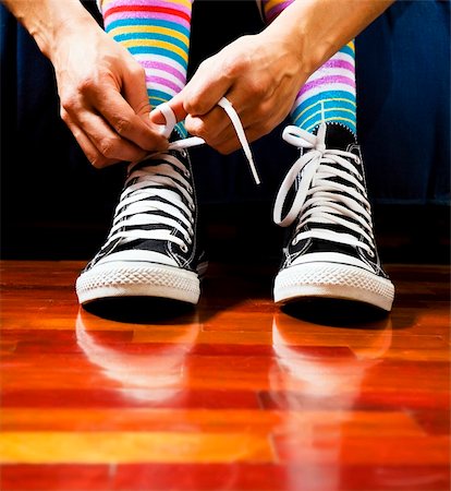 Close up of a teenager tying his footwear Stock Photo - Budget Royalty-Free & Subscription, Code: 400-04004276