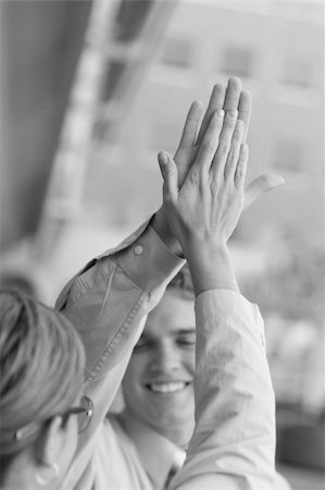 Business team dressed in tan clothes give each other a high five accomplishment Stock Photo - Budget Royalty-Free & Subscription, Code: 400-04005281