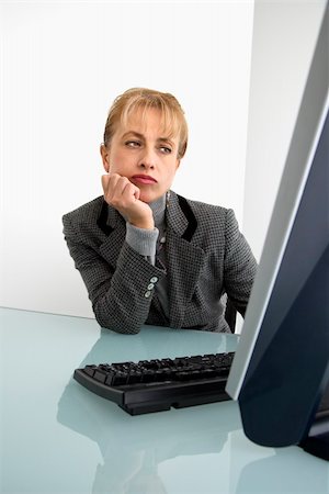 Caucasian woman looking bored at computer. Stock Photo - Budget Royalty-Free & Subscription, Code: 400-04006196