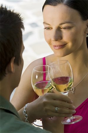 simsearch:400-04655735,k - A beautiful young woman and her boyfriend toasting with glasses of white wine while bathed in summer sunshine Stockbilder - Microstock & Abonnement, Bildnummer: 400-04006718
