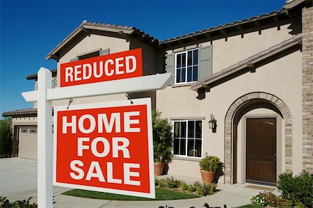 simsearch:400-03938701,k - Reduced Home For Sale Sign in Front of New House on Deep Blue Sky Stock Photo - Budget Royalty-Free & Subscription, Code: 400-04007077