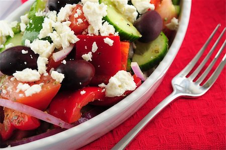 person eating greek salad - Greek salad with feta cheese and black kalamata olives Stock Photo - Budget Royalty-Free & Subscription, Code: 400-04007236