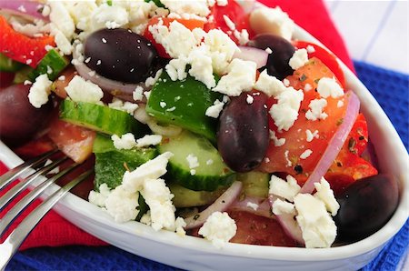 person eating greek salad - Greek salad with feta cheese and black kalamata olives Stock Photo - Budget Royalty-Free & Subscription, Code: 400-04007237