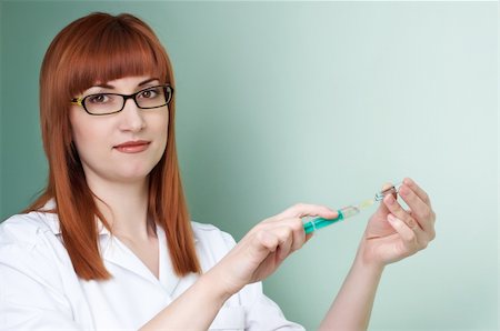 red-haired doctor in white smock filling the syringe. lot of copyspace. Stock Photo - Budget Royalty-Free & Subscription, Code: 400-04007404