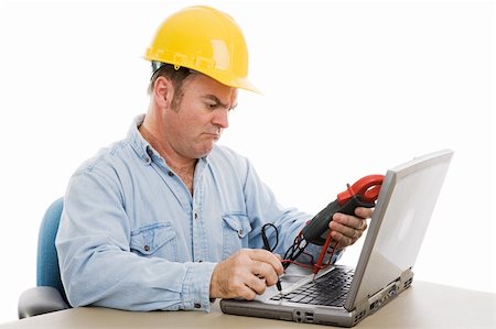 simsearch:400-07165423,k - Electrician using a voltage meter to try and fix a laptop computer.  Isolated on white. Foto de stock - Royalty-Free Super Valor e Assinatura, Número: 400-04007743