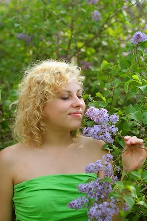 Beautiful young girl with spray of lilac Stock Photo - Budget Royalty-Free & Subscription, Code: 400-04008206