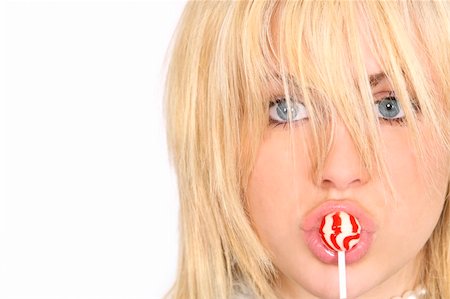 sucking on popsicle - A beautiful young model sucking on a red and white lollipop Photographie de stock - Aubaine LD & Abonnement, Code: 400-04008246