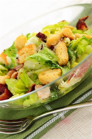 Caesar salad with croutons and bacon bits served in a glass bowl Stock Photo - Budget Royalty-Free & Subscription, Code: 400-04008365