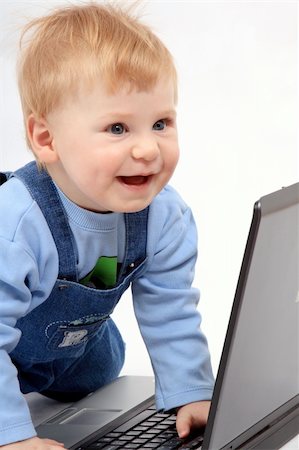 sergeitelegin (artist) - The happy dressed child look at the screen laptop Stock Photo - Budget Royalty-Free & Subscription, Code: 400-04008806