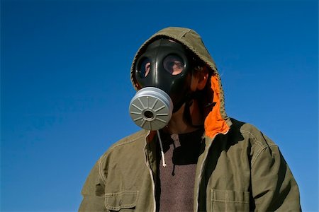 man with a gas mask and coat against blue sky Stock Photo - Budget Royalty-Free & Subscription, Code: 400-04008981