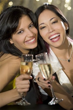 simsearch:400-07112758,k - Two attractive young women, one Asian one Hispanic, enjoying champagne in a nightclub Fotografie stock - Microstock e Abbonamento, Codice: 400-04009263