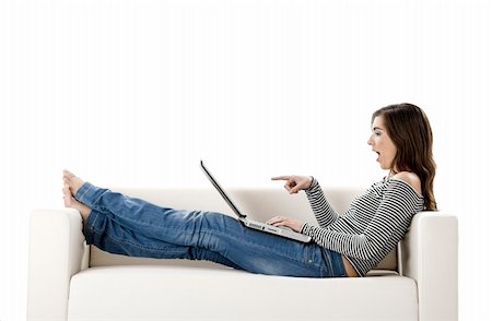 simsearch:400-04540351,k - Beautiful woman on a white sofa with a laptop Stock Photo - Budget Royalty-Free & Subscription, Code: 400-04009393