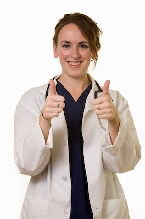 simsearch:400-03995908,k - Young brunette woman doctor wearing white lab coat holding two thumbs up wearing a stethoscope around shoulders smiling standing on white background Stock Photo - Budget Royalty-Free & Subscription, Code: 400-04009436